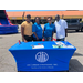 Four individuals standing behind the USI, Urban Strategies, Inc. booth.