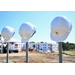 Three white construction hard hats with the Durham Housing Authority logo individually suspended on three grey pools.