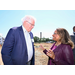 A man and a woman sharing a discussion while outside at the Ground Breaking Ceremony.