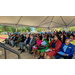 A wide shot of the crowd listening to the speakers.