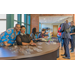 Two women smiling for the camera while behind a table to hand out clear name tag holders.