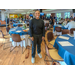 An individual standing between dining tables smiling for the camera.