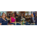 Two woman and two men smiling around a dinning table.