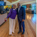 A man and a woman with the buffet bar in the background.