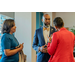 Chief Executive Officer, Anthony Scott, speaking with two women.