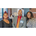 A man and two women smiling big for the camera.