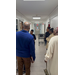 Individuals standing in a hallway admiring the Christmas door decorations.